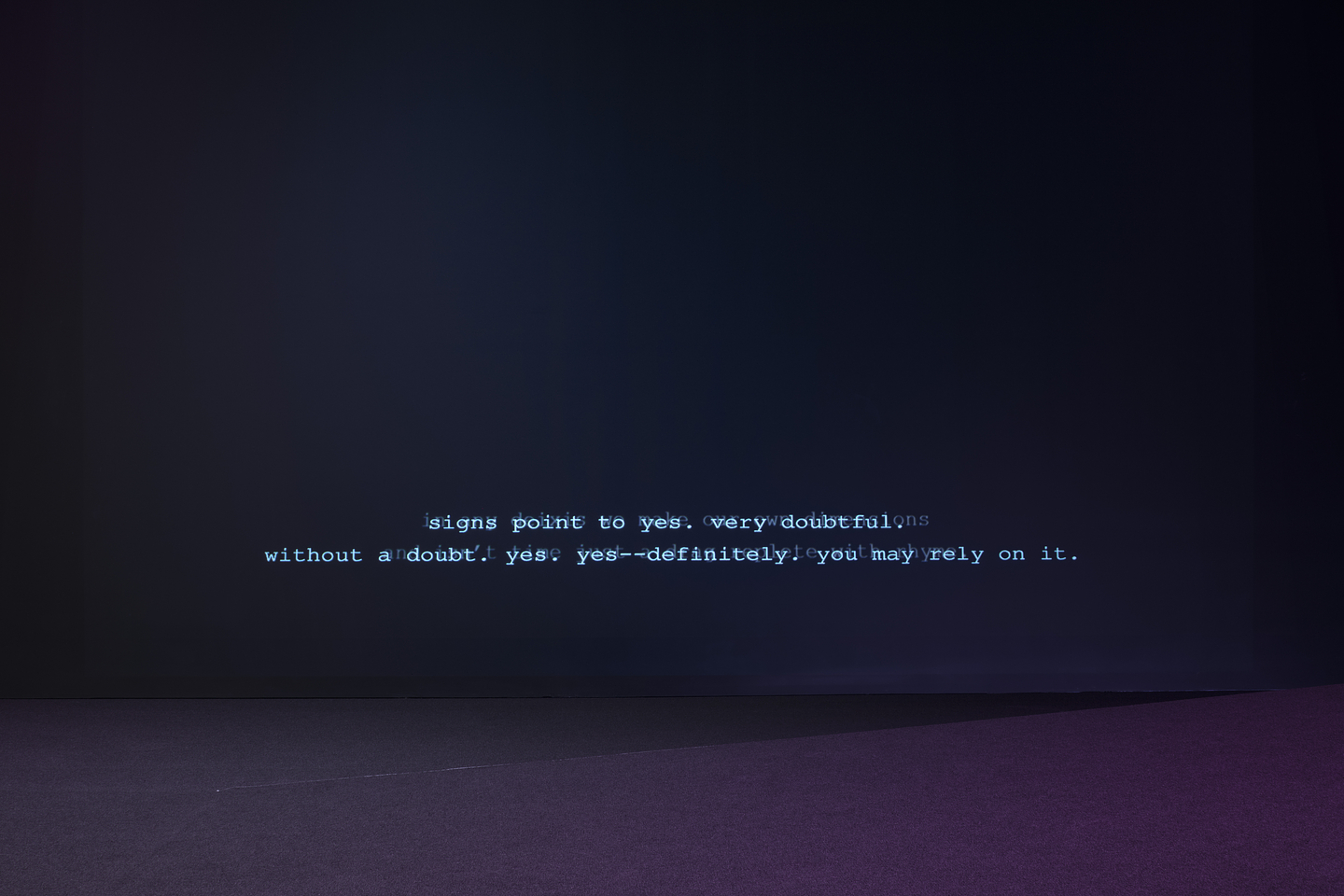 A deep indigo wall hosts two lines of overlapping white open captions. The legible text reads: “signs point to yes. very doubtful. without a doubt. yes. yes--definitely . you may rely on it.”